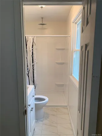 a view of a livingroom with furniture and staircase