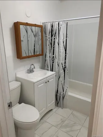 a kitchen with a table chairs refrigerator and microwave