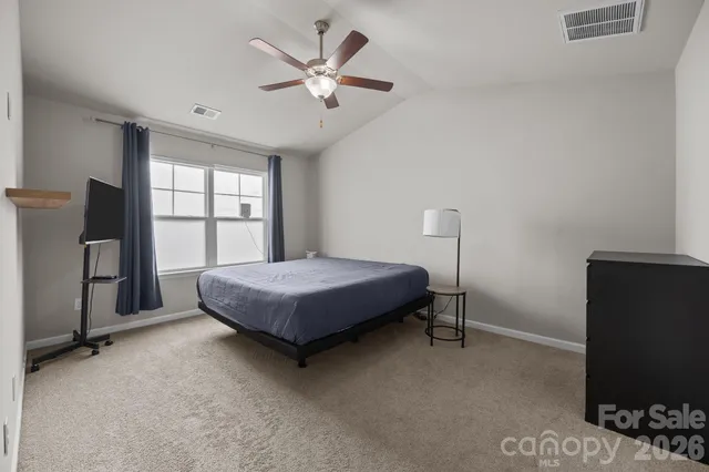 a bedroom with a large bed and a large window