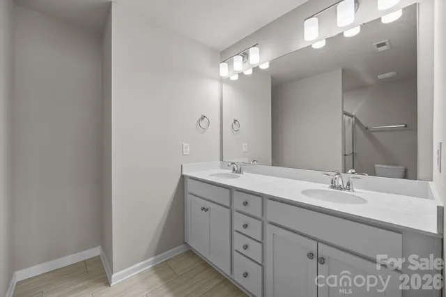 a white toilet sitting next to a shower