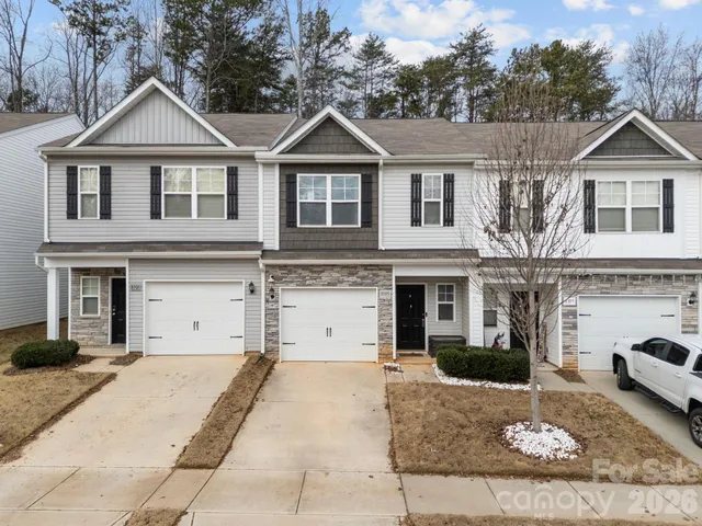 a view of a white house with large windows