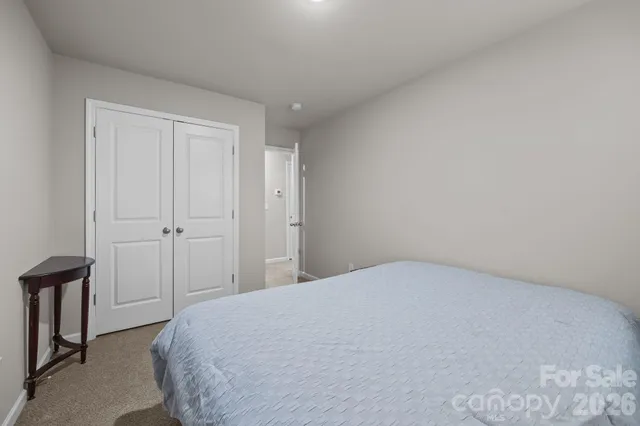 a living room with furniture and a air conditioner vent