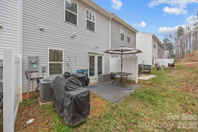 a view of a patio with table and chairs with wooden fence