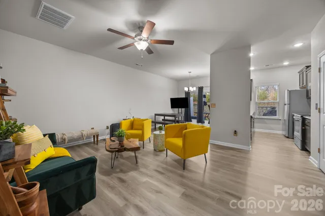 a living room with furniture and kitchen view