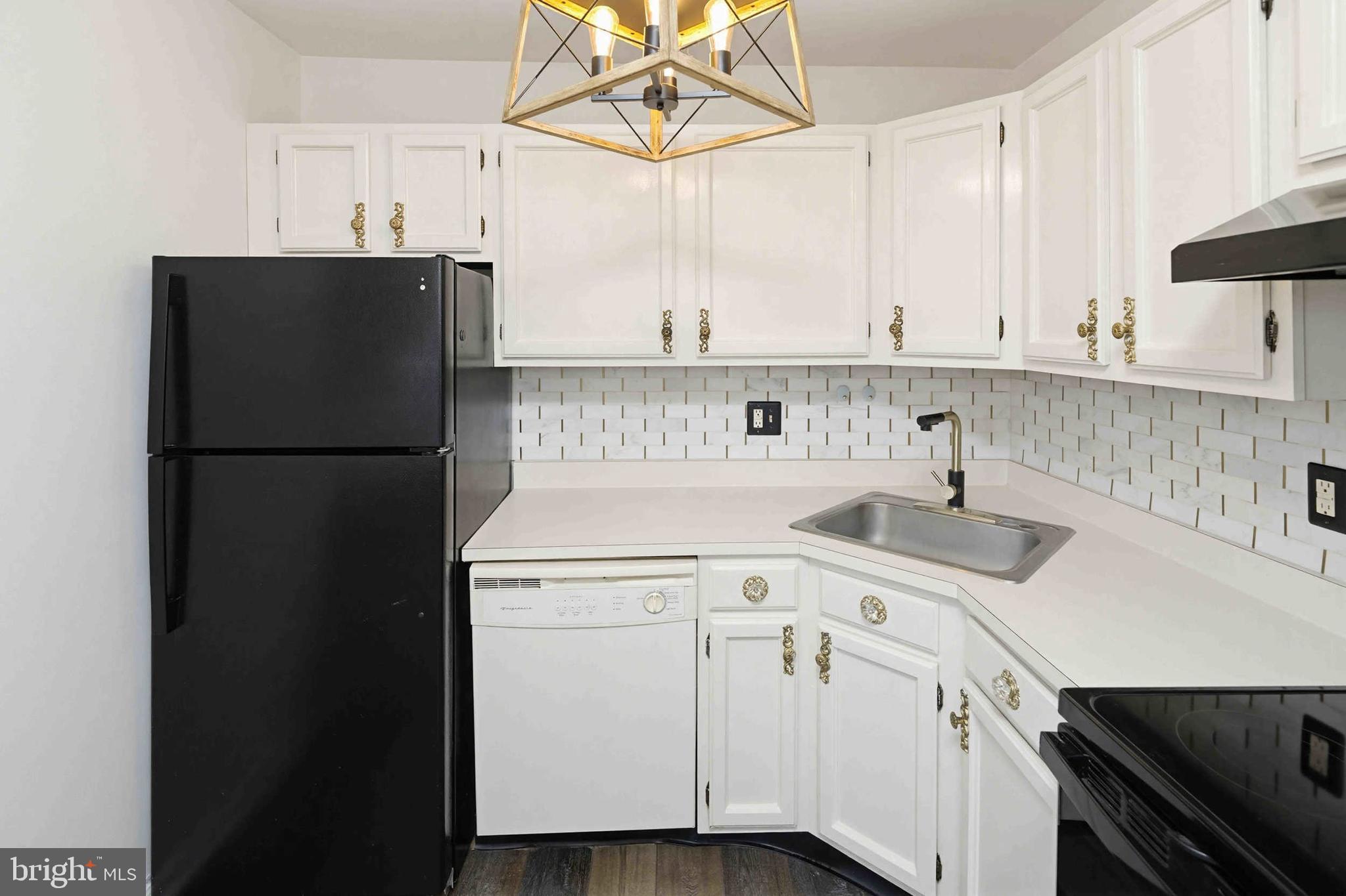 403 South Main Street, Unit S200 Doylestown, PA 18901 - Photo 11 of 26 a kitchen with a sink a refrigerator and cabinets