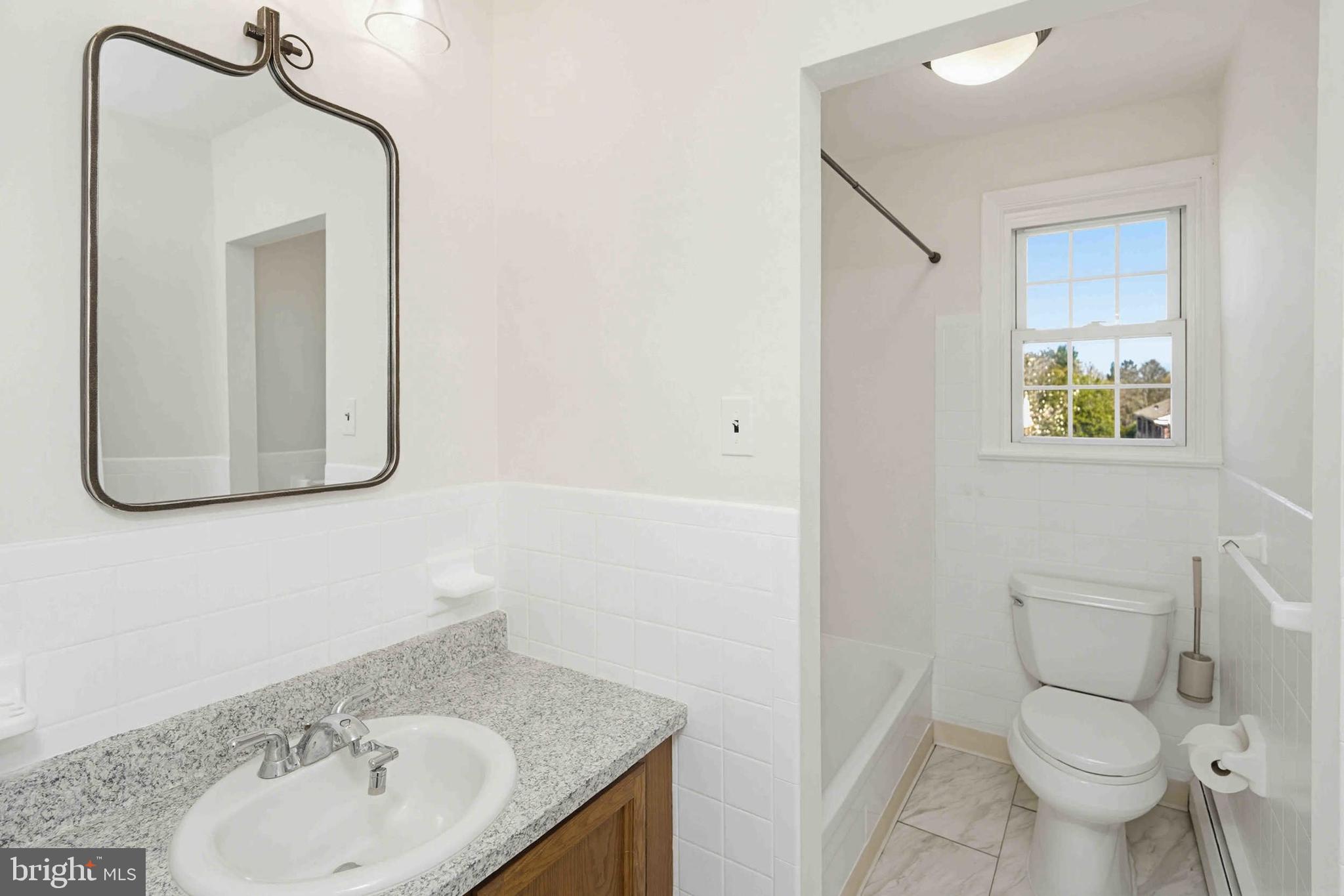 403 South Main Street, Unit S200 Doylestown, PA 18901 - Photo 17 of 26 a bathroom with a toilet sink and mirror
