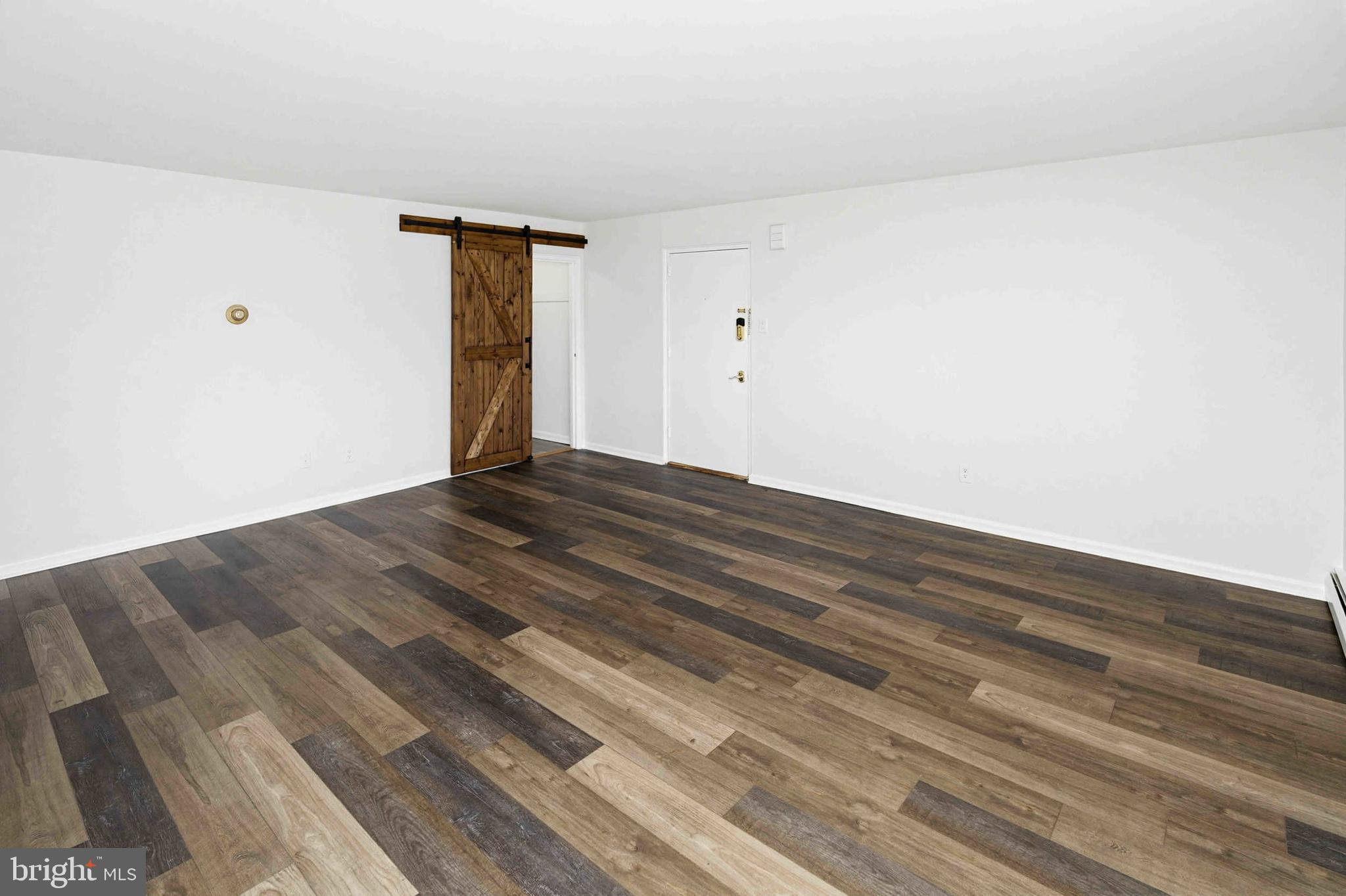 403 South Main Street, Unit S200 Doylestown, PA 18901 - Photo 9 of 26 a view of an empty room with wooden floor and a window