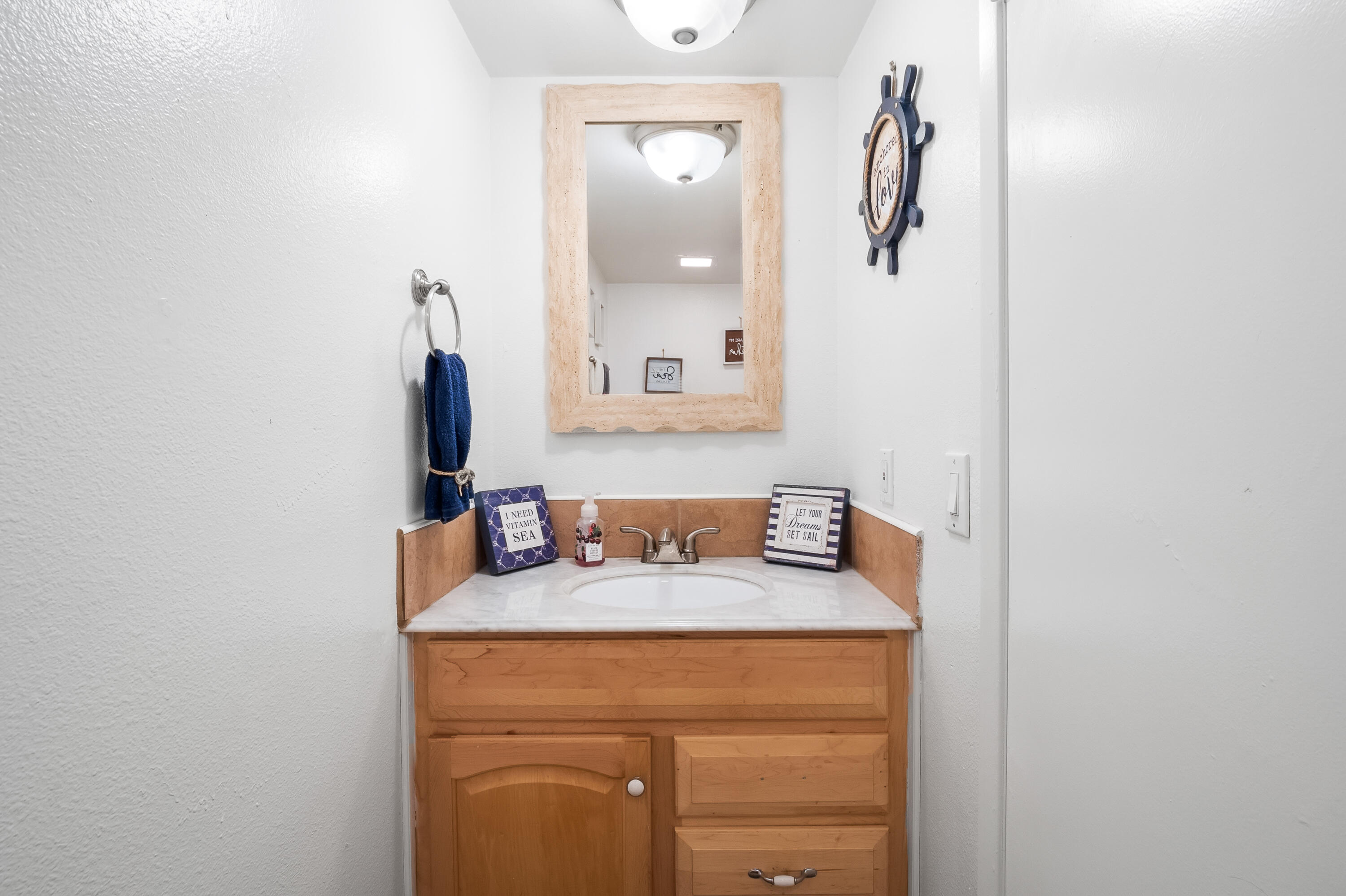 44200 Kingtree Avenue, Unit 24 Lancaster, CA 93534 - Photo 13 of 23 a bathroom with a sink and a mirror
