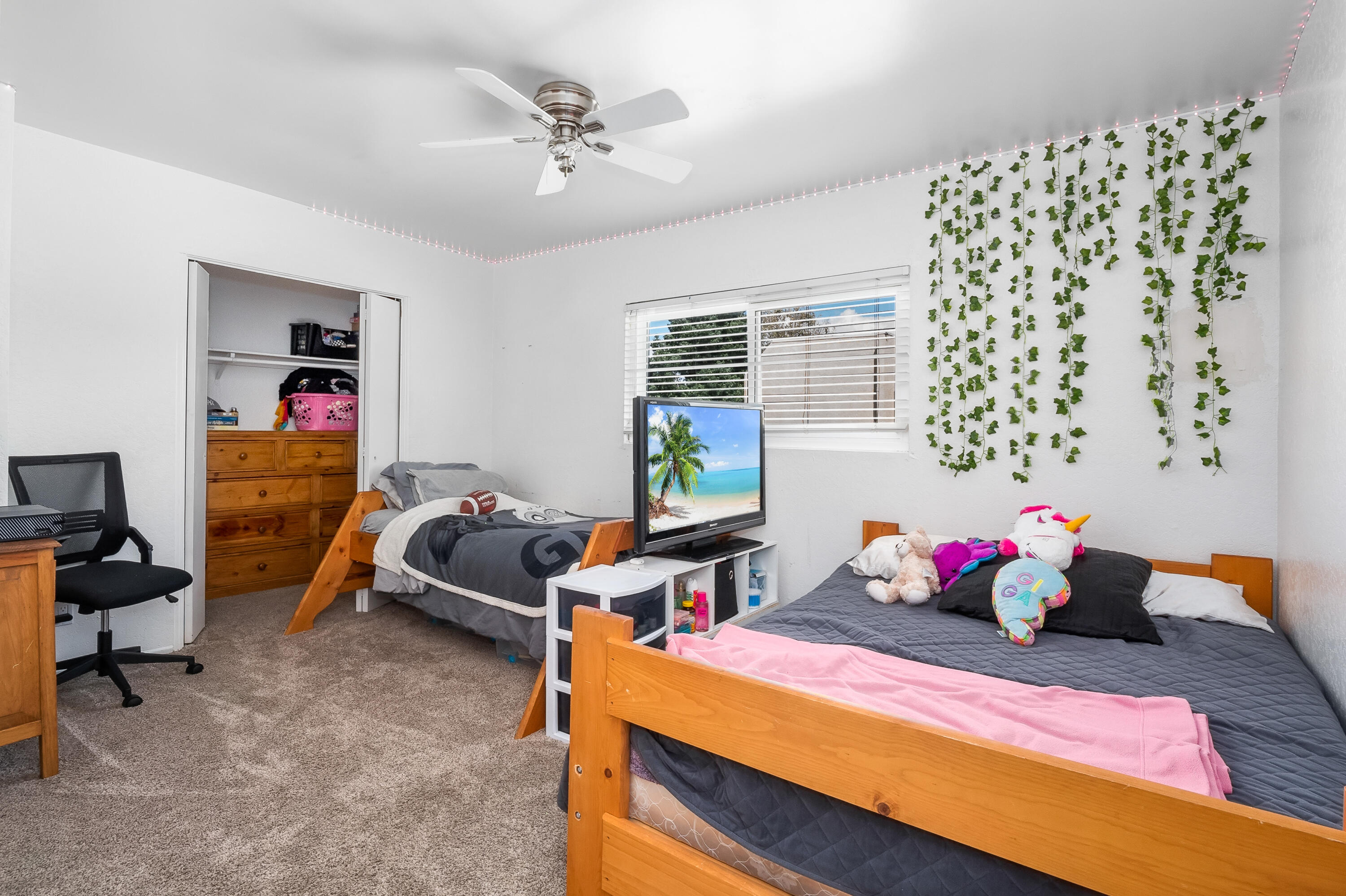 44200 Kingtree Avenue, Unit 24 Lancaster, CA 93534 - Photo 14 of 23 a bedroom with a bed and a chandelier