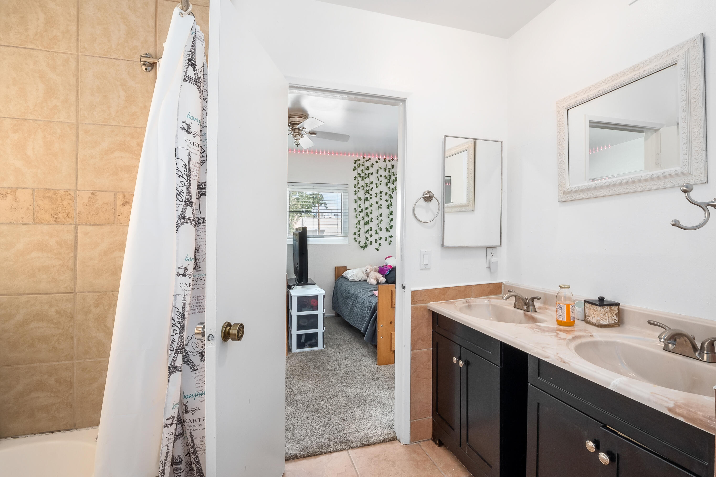 44200 Kingtree Avenue, Unit 24 Lancaster, CA 93534 - Photo 19 of 23 a bathroom with a double vanity sink mirror and shower