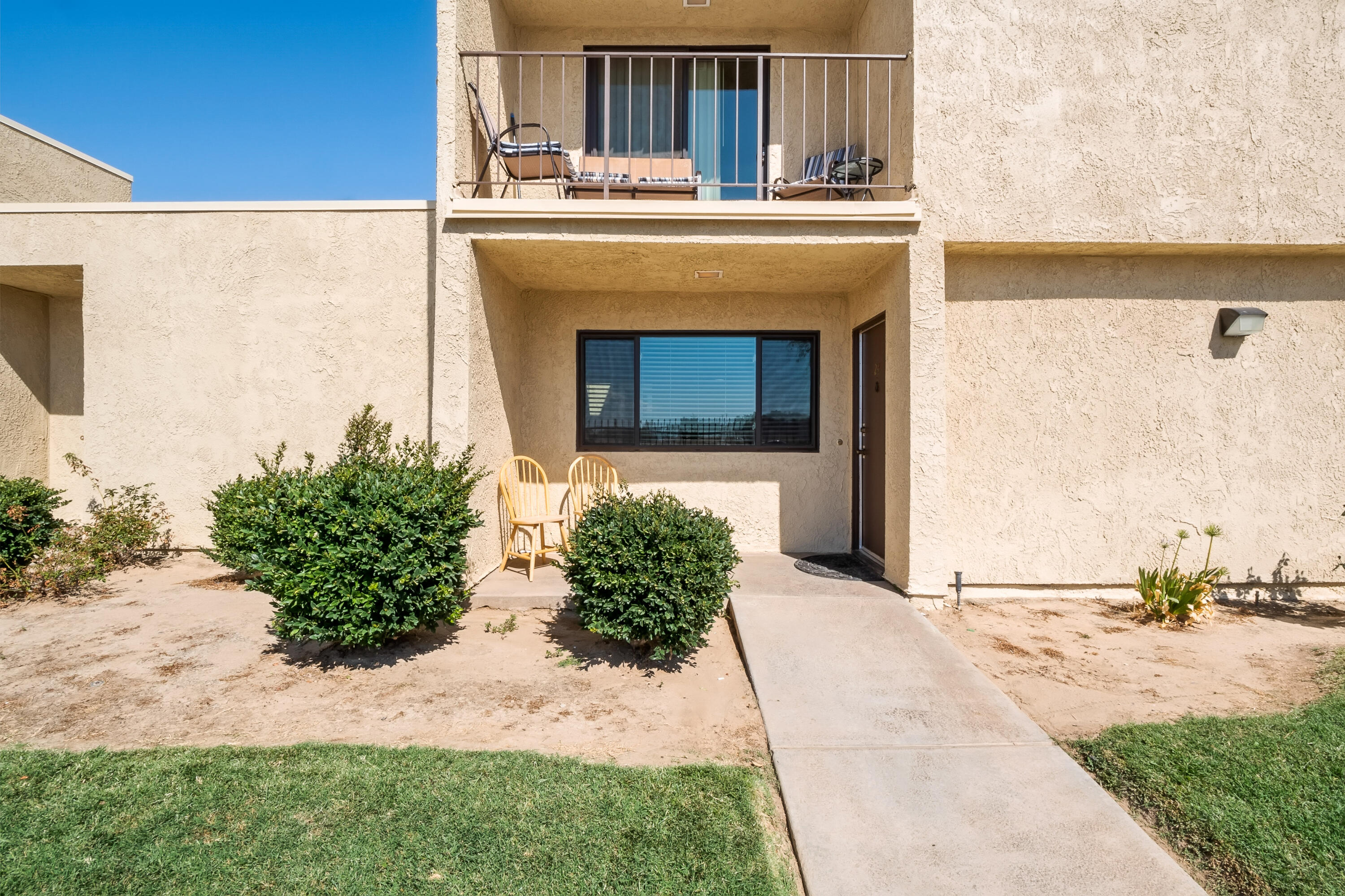 44200 Kingtree Avenue, Unit 24 Lancaster, CA 93534 - Photo 3 of 23 a front view of a house with a yard
