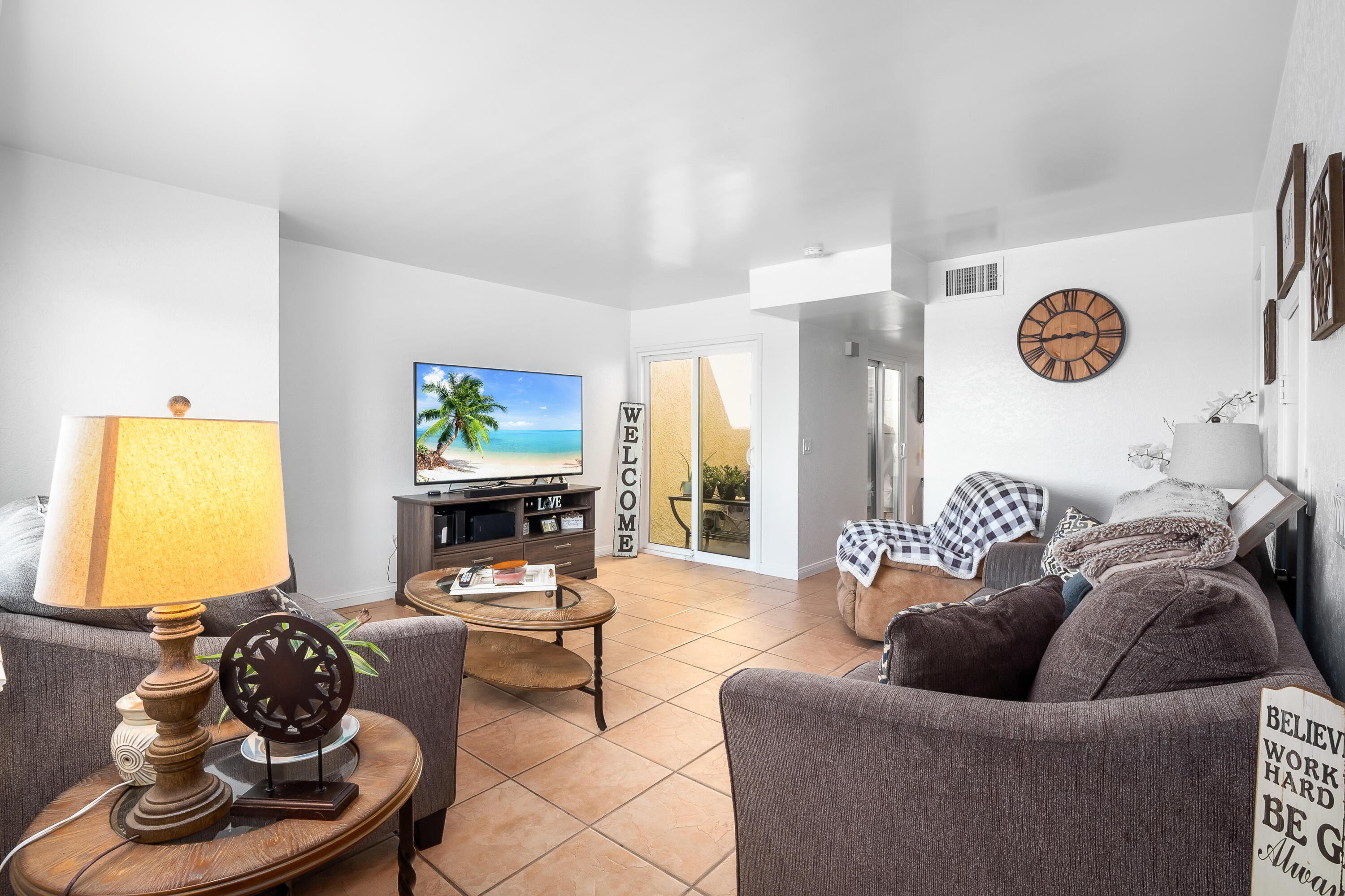 44200 Kingtree Avenue, Unit 24 Lancaster, CA 93534 - Photo 4 of 23 a living room with furniture and a wooden floor