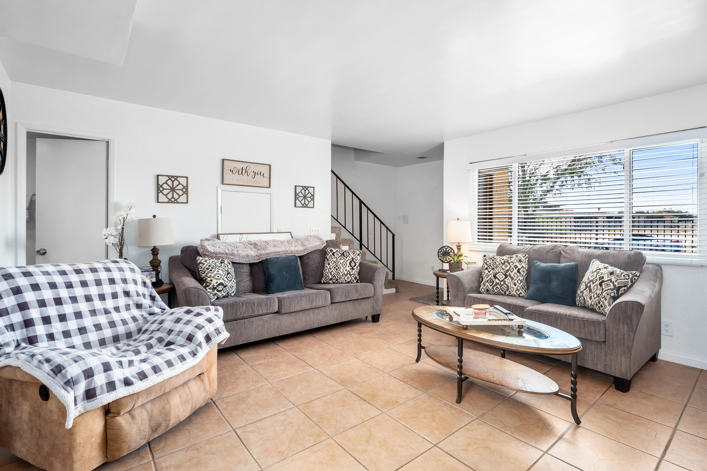 44200 Kingtree Avenue, Unit 24 Lancaster, CA 93534 - Photo 5 of 23 a living room with furniture and a night stand
