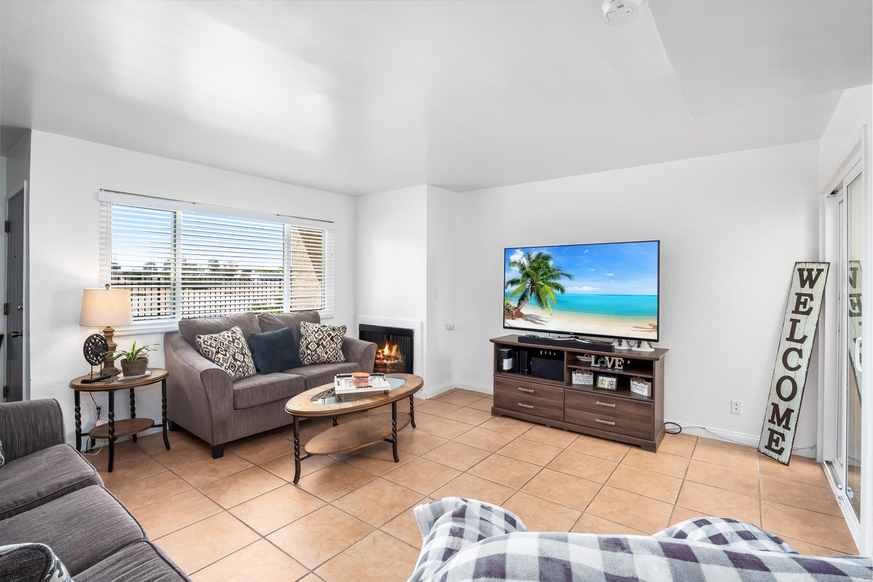 44200 Kingtree Avenue, Unit 24 Lancaster, CA 93534 - Photo 6 of 23 a living room with furniture and a flat screen tv