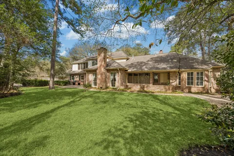 a front view of a house with a yard and trees