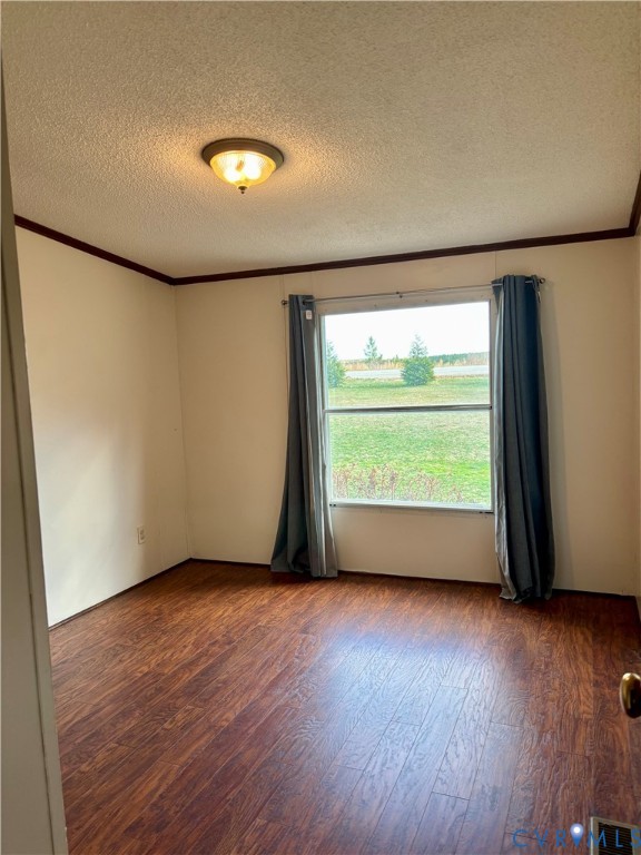 1225 Beech Forest Road Kenbridge, VA 23944 - Photo 16 of 33 an empty room with wooden floor and windows