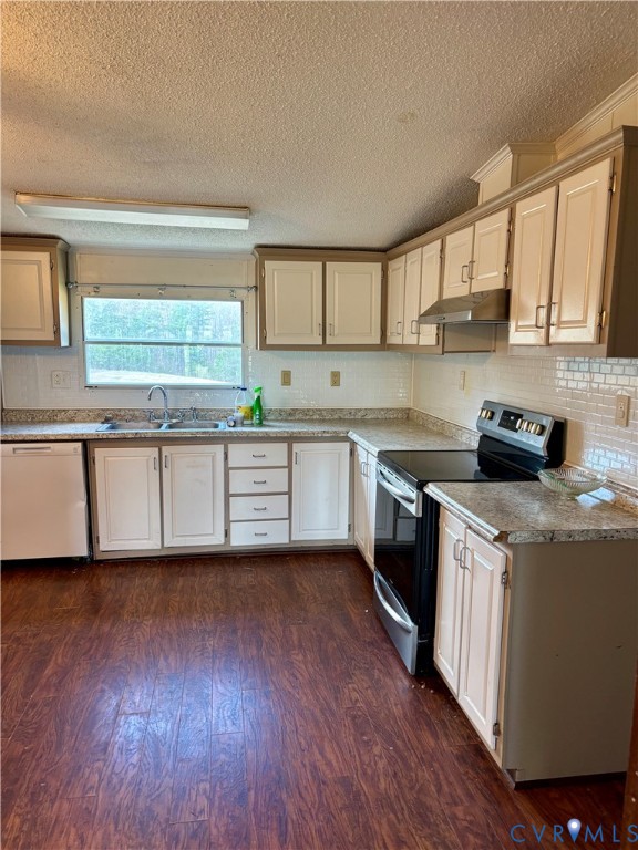 1225 Beech Forest Road Kenbridge, VA 23944 - Photo 10 of 33 a kitchen with wooden floors and white appliances