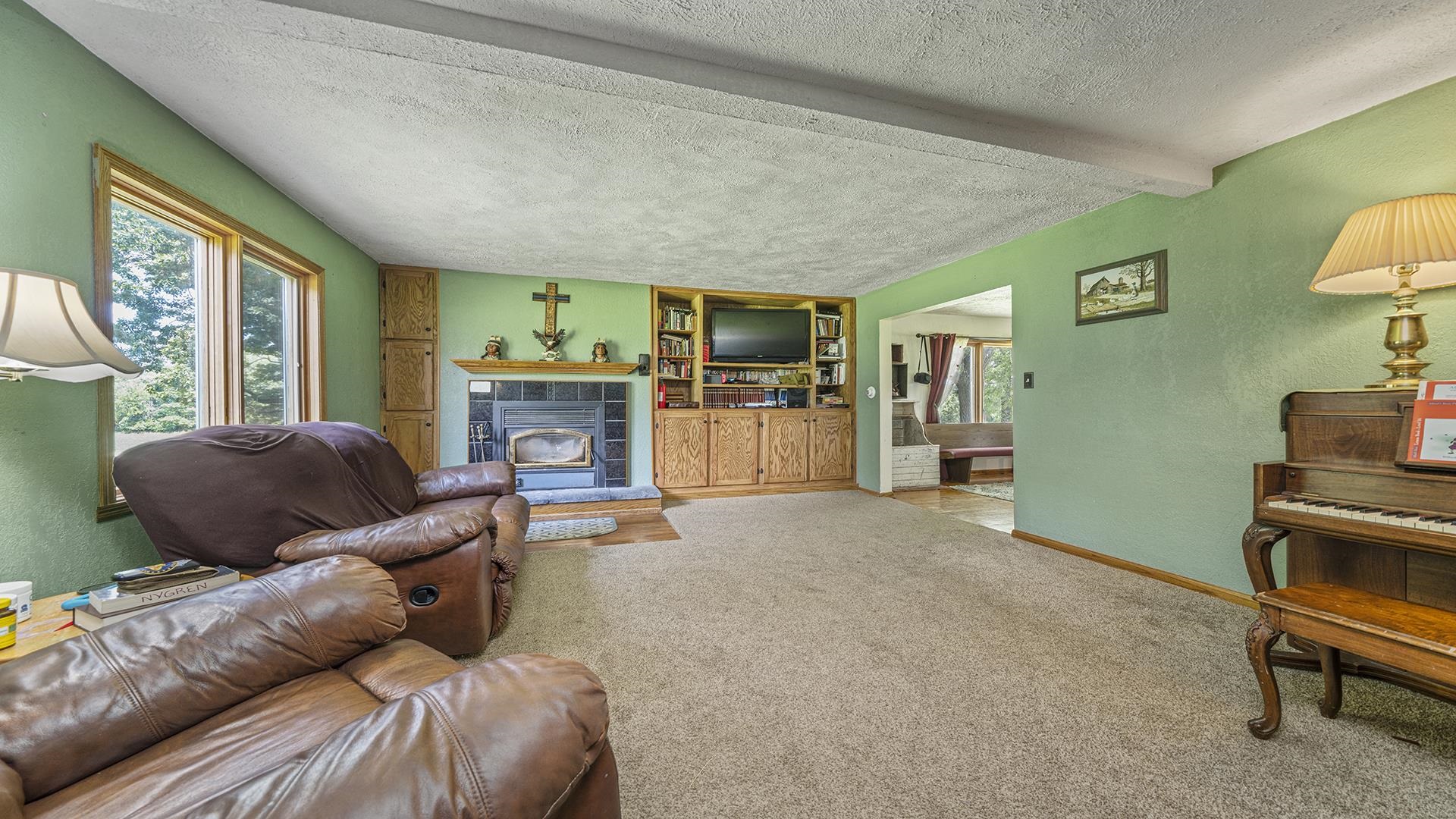 12112 North Hoisington Road Byron, IL 61010 - Photo 11 of 45 a living room with furniture and a fireplace
