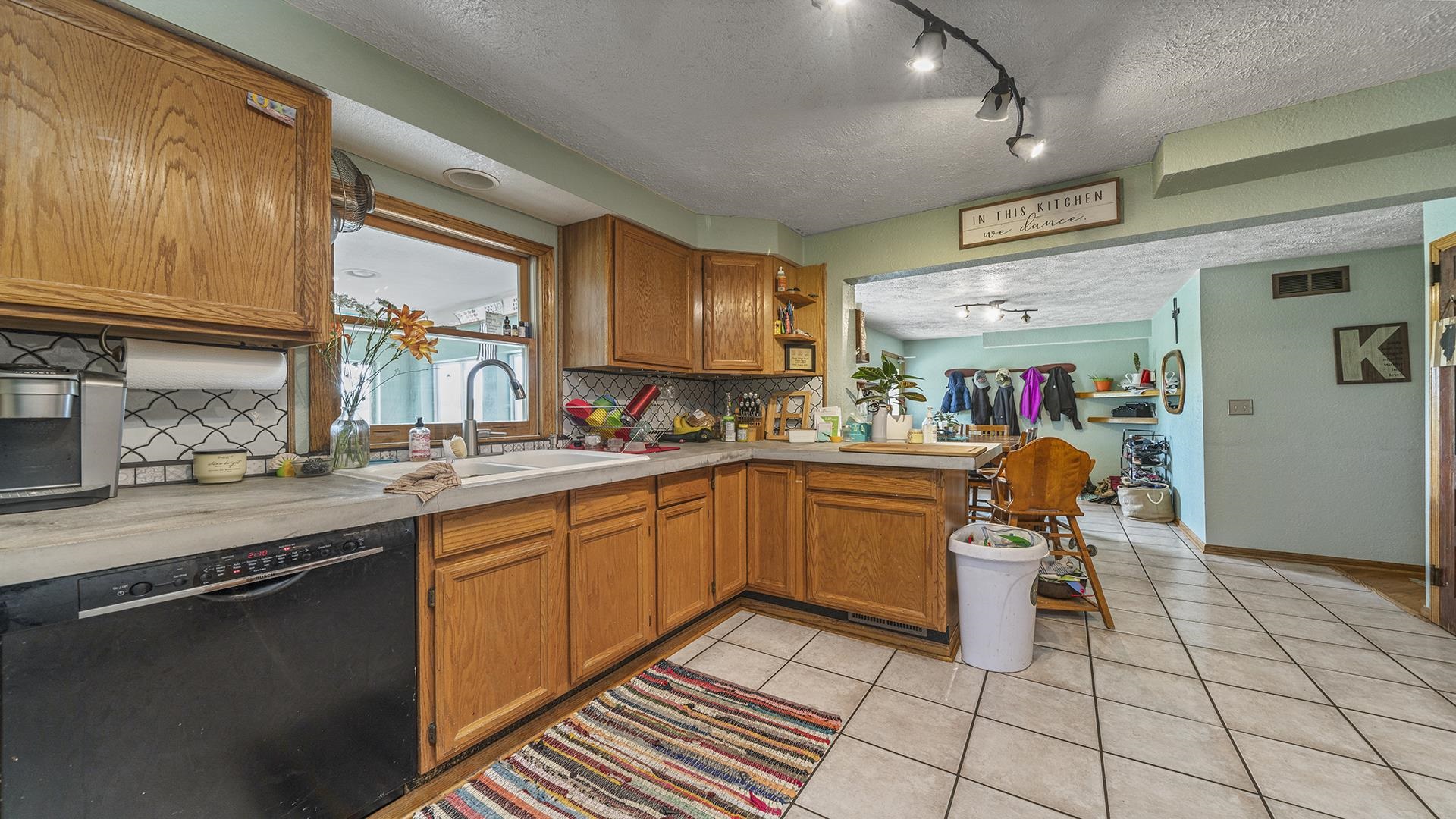 12112 North Hoisington Road Byron, IL 61010 - Photo 9 of 45 a kitchen with stainless steel appliances granite countertop a sink and cabinets