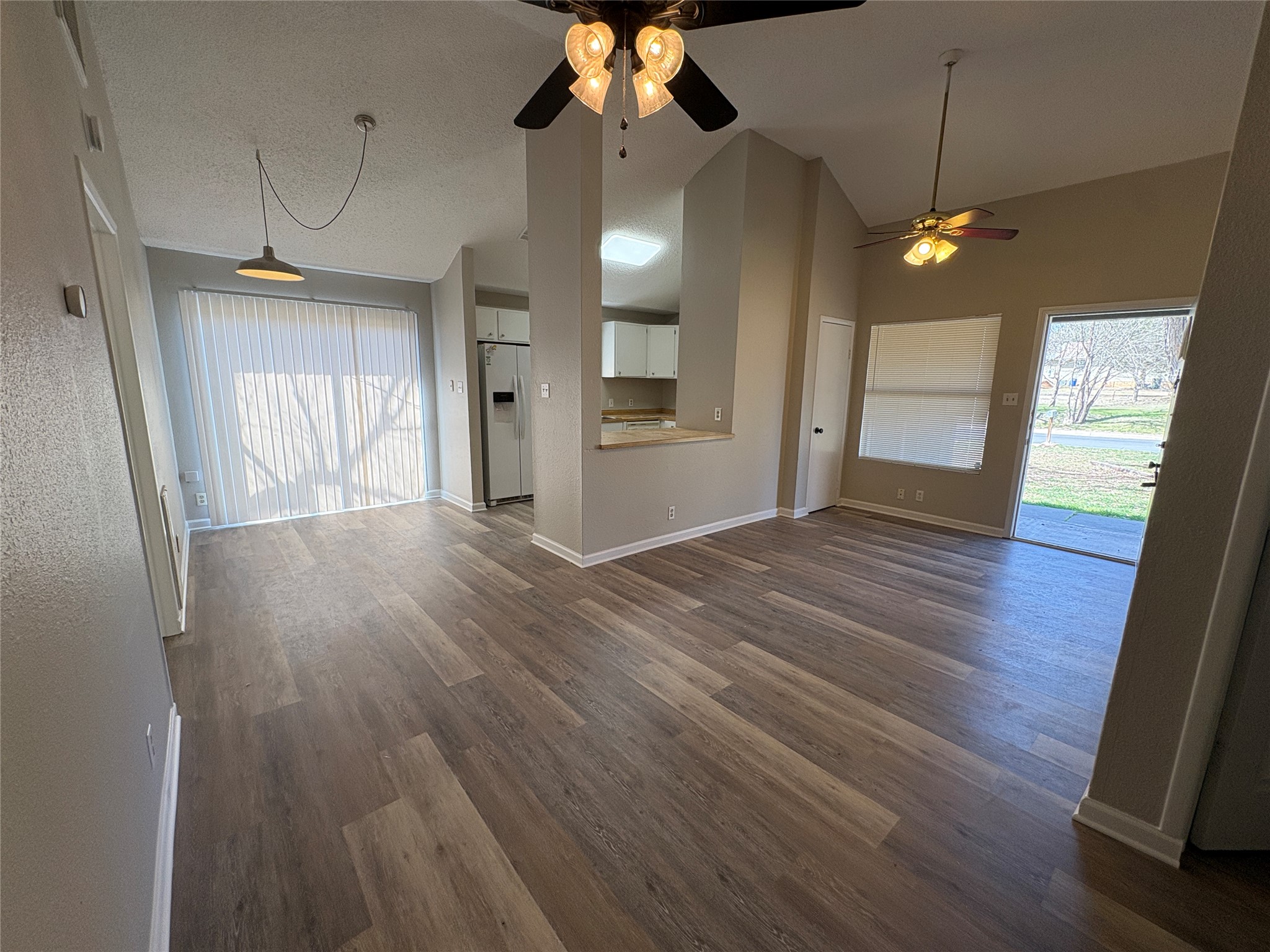 601 Valley Street San Marcos, TX 78666 - Photo 5 of 10 an empty room with wooden floor and windows