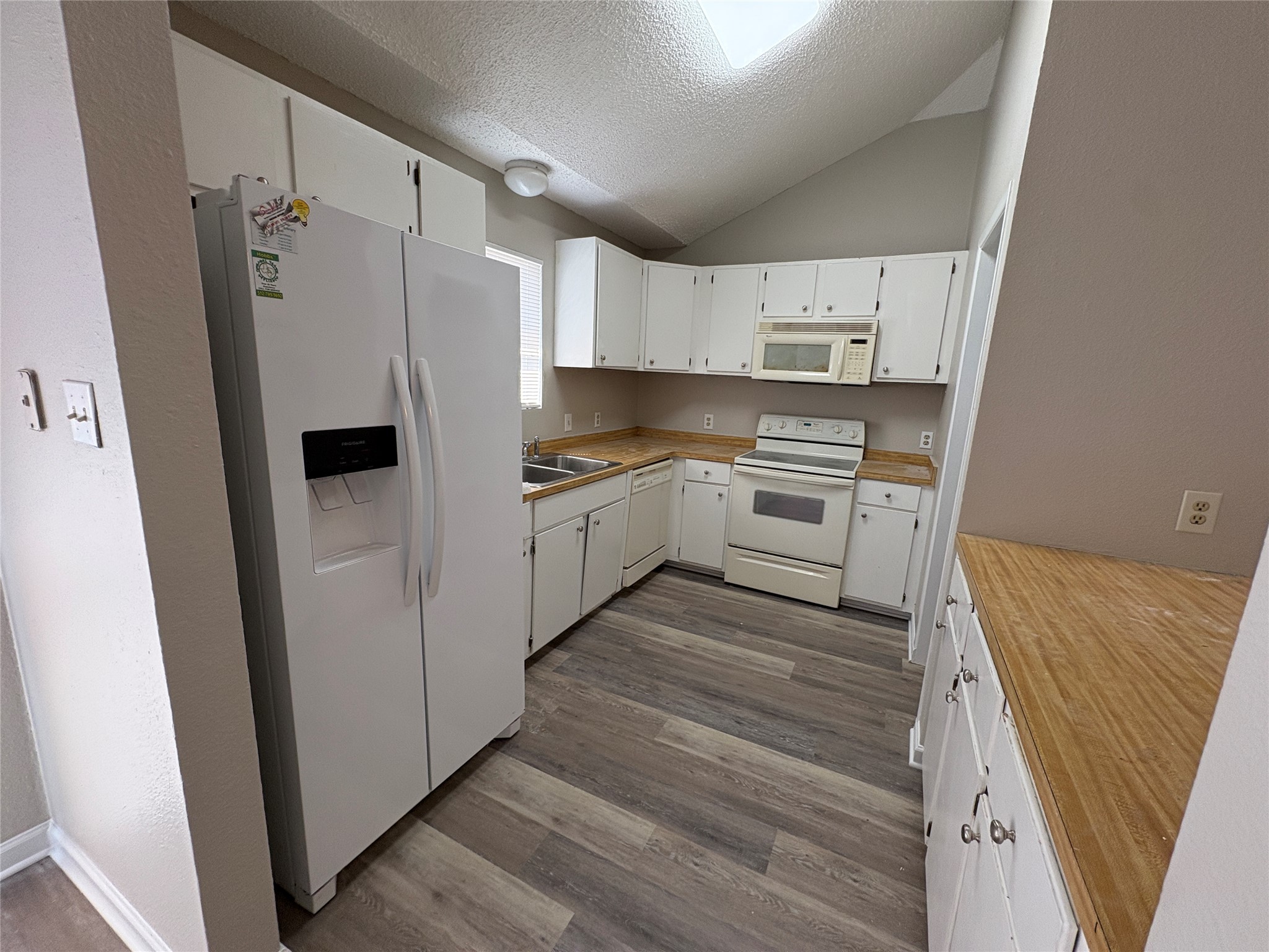 601 Valley Street San Marcos, TX 78666 - Photo 6 of 10 a kitchen with white cabinets and white stainless steel appliances