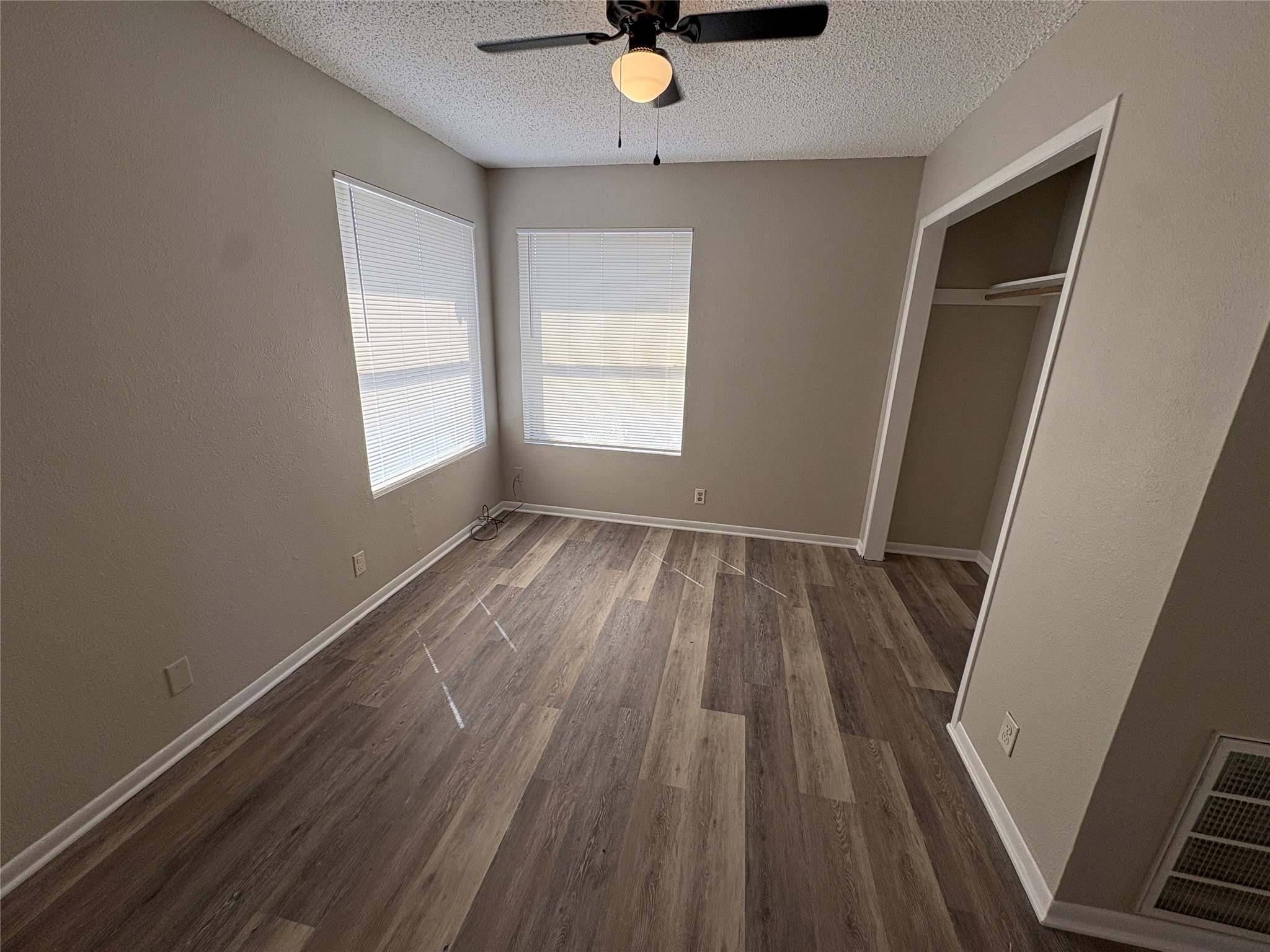 601 Valley Street San Marcos, TX 78666 - Photo 7 of 10 a view of an empty room with wooden floor and a window