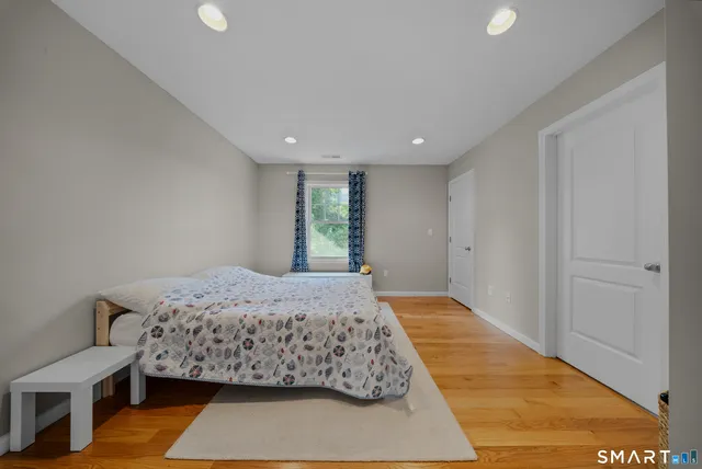 a bedroom with a bed and a painting