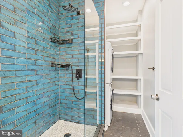 a bathroom with a glass shower door