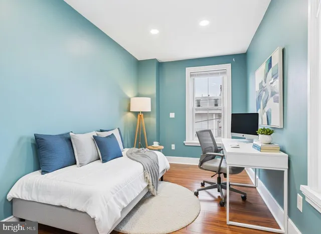 a bedroom with a bed and a desk