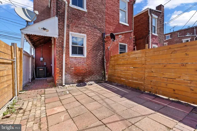 a view of a brick house with many windows