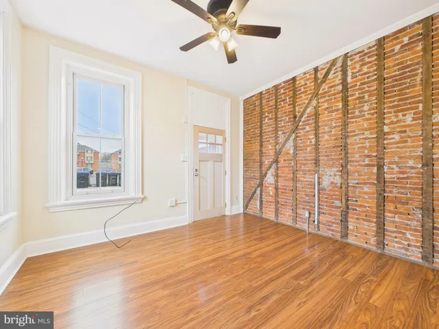 a view of an empty room with a window and closet