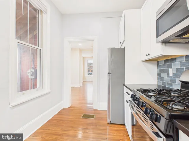 a kitchen with stainless steel appliances granite countertop a stove and a refrigerator