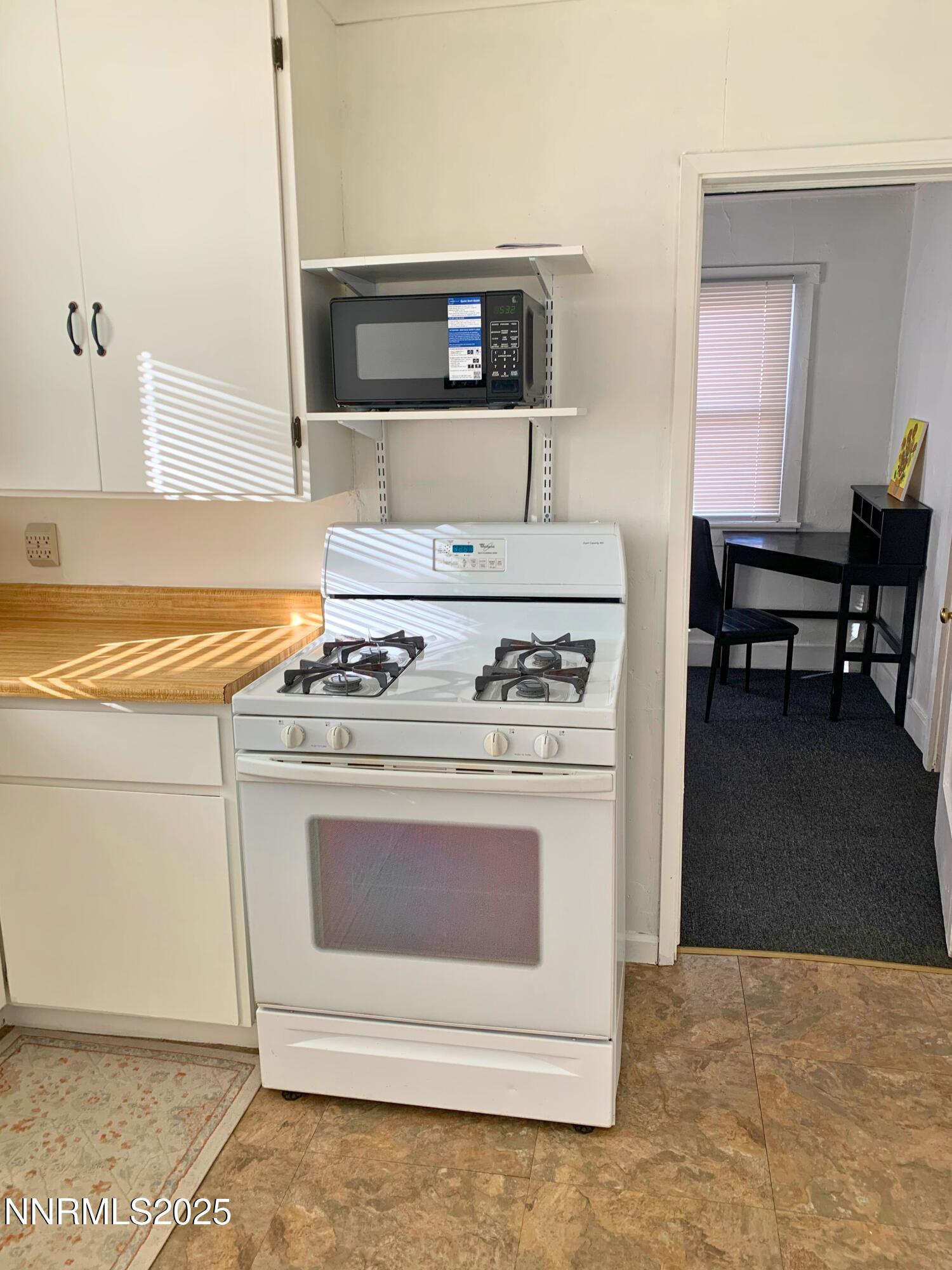 1151 Seminary Avenue Reno, NV 89503 - Photo 8 of 12 a stove top oven sitting inside of a kitchen