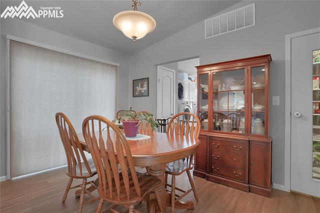 9990 North Log Road Calhan, CO 80808 - Photo 19 of 29 Dining room has a pantry and walks out onto the back deck