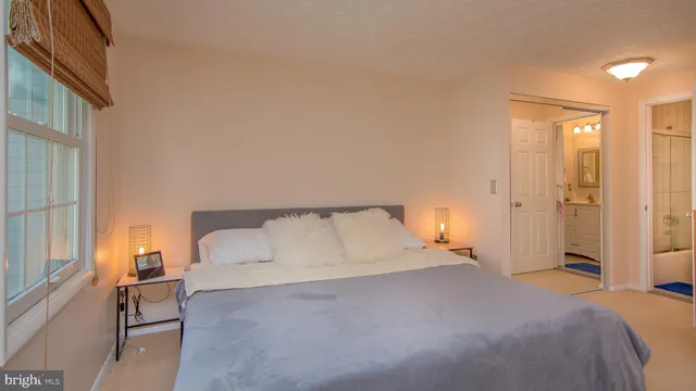 a bedroom with a bed and a night lamp