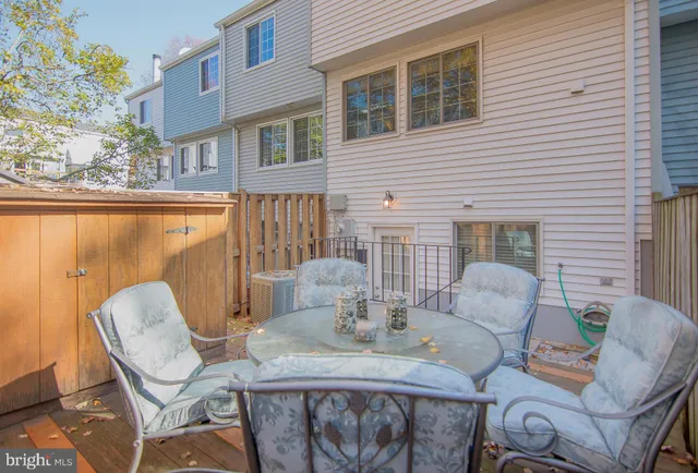 a patio with a table and chairs