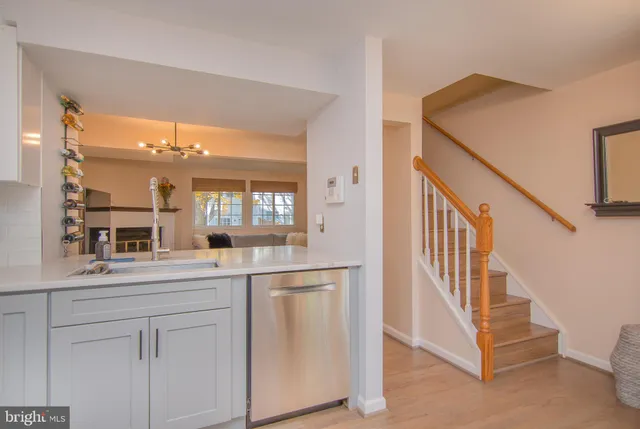a kitchen with white cabinets and a window
