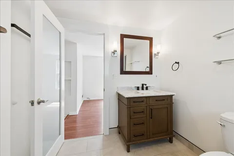a bathroom with a shower a toilet and a sink