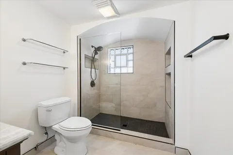 a view of a livingroom with window and cabinet