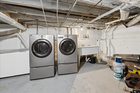 a view of a backyard with a patio and iron fence