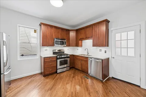a kitchen with granite countertop a stove top oven sink and cabinets