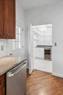 a kitchen with granite countertop a sink cabinets and stainless steel appliances