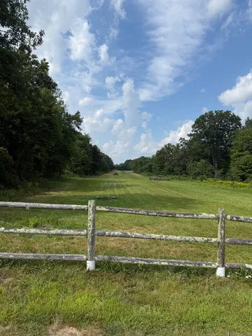 a view of a green field with clear sky