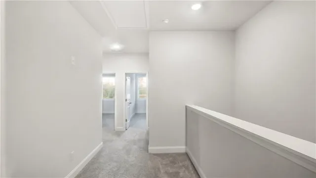 a view of hallway with bathroom