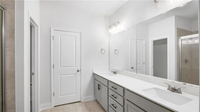 a bathroom with double vanity sinks and a mirror