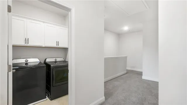 a view of storage and utility room with washer and dryer