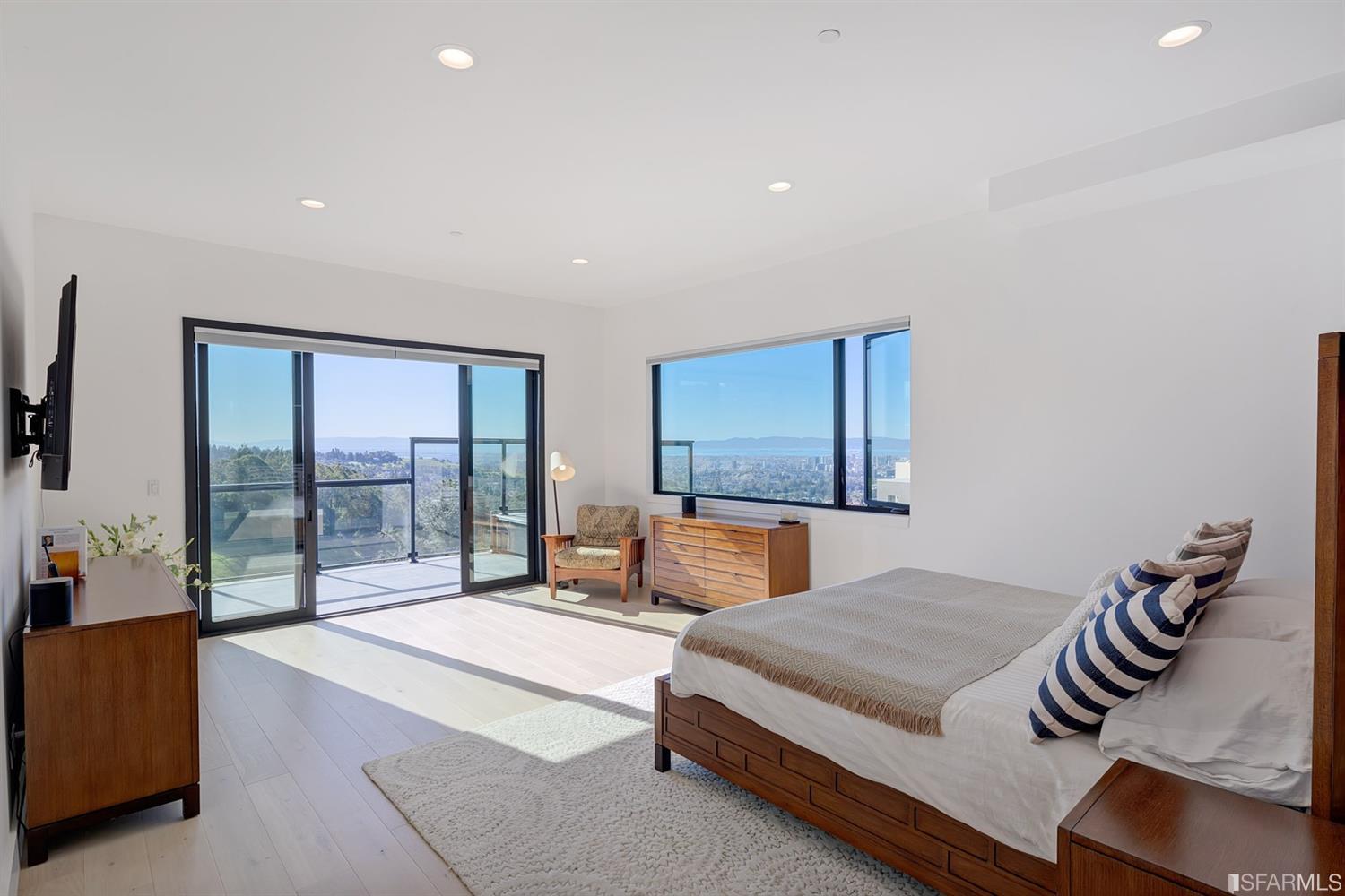 1538 Grand View Drive Berkeley, CA 94705 - Photo 12 of 30 a bedroom with a large bed and a balcony view