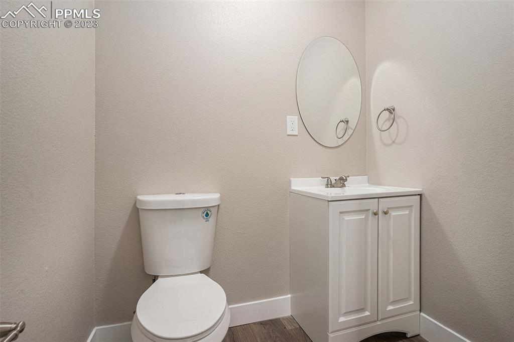 11615 Oil Well Road Calhan, CO 80808 - Photo 13 of 37 a bathroom with a toilet a sink and mirror