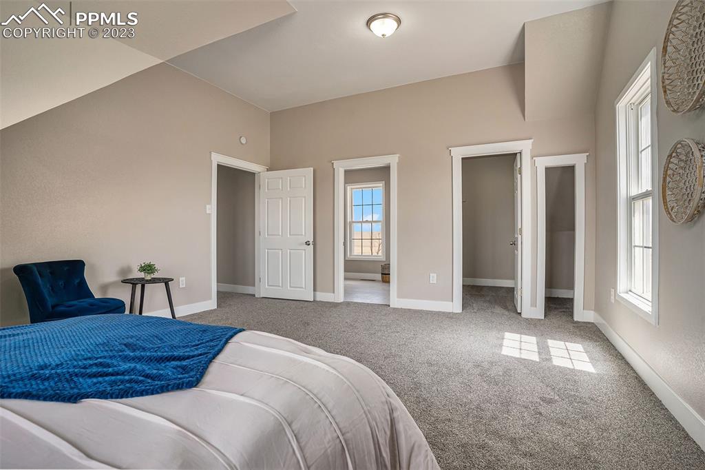 11615 Oil Well Road Calhan, CO 80808 - Photo 18 of 37 a bedroom with a large bed and a window