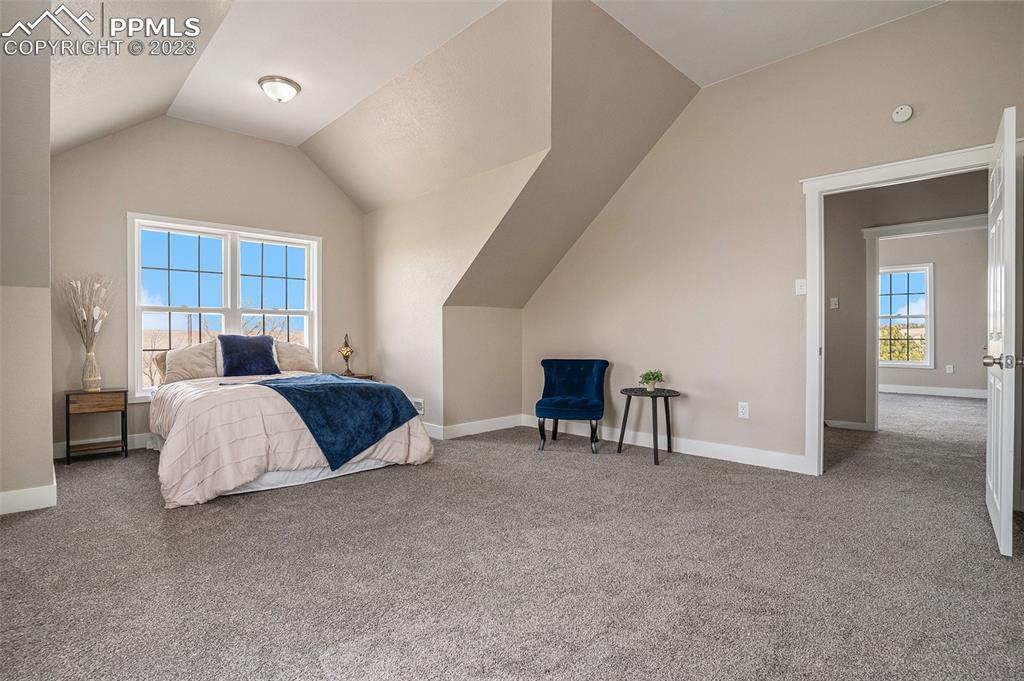 11615 Oil Well Road Calhan, CO 80808 - Photo 19 of 37 a spacious bedroom with a bed and a table